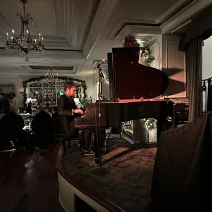 a man playing a grand piano
