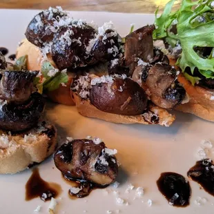 Marinated mushrooms roasted in butter, thyme, with whipped shallot butter &amp; topped with arugula &amp; parmesan on crostini
