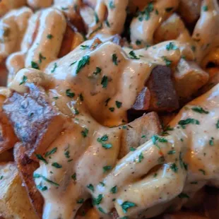 Papas bravas-fried potatoes topped with a creamy&amp; spicy aioli sauce.