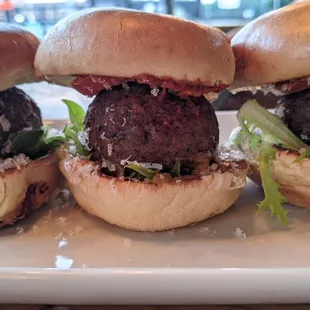 Beef sliders topped Parmesan, romesco sauce, lettuce &amp; tomato. Finished with melty cheddar cheese &amp; caper aioli.