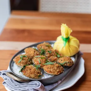 a plate of fried clams on a wooden table