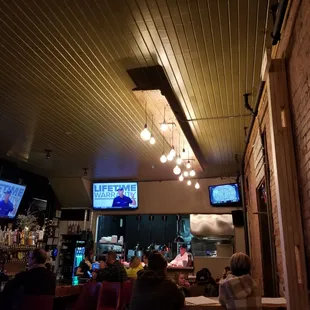 Cool lighting and some of the TVs at the bar