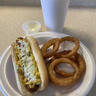 Beef hotdog with coleslaw and mustard, onion rings and an unsweet tea