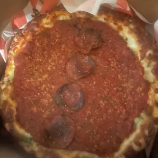 Pepperoni and sausage with green peppers personal size deep dish - about the circumference of a dinner plate