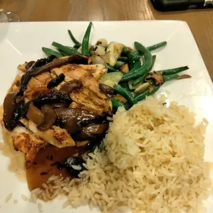 Pan seared chicken with rice pilaf and seasonal vegetables