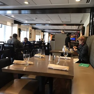 people sitting at tables in a restaurant