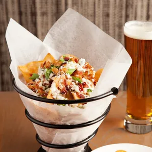 a basket of food and a glass of beer