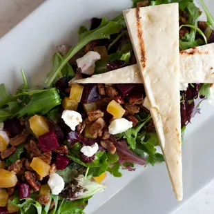 a plate of salad with pita chips