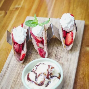 BUÑUELO TACOS  crispy buñuelo shells, fresh strawberries, whipped cream, vanilla ice cream