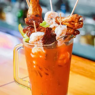 Touchdown Bloody Mary Pitcher: celery, stuffed olives, pickles, candied bacon, pepper jack cheese, smoked jerky, cocktail shrimp, wings