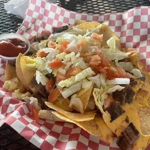 Fajita Nachos - choice of beef or chicken, topped with queso, lettuce, tomatoes (no jalapeños)