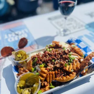 Waffle Fried with bacon, jalapeños, cheese sauce, and green onions