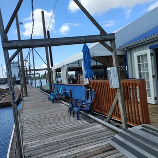a view of a dock with chairs and umbrellas