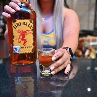 a woman holding a glass of alcohol