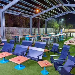 tables and chairs set up on artificial turf