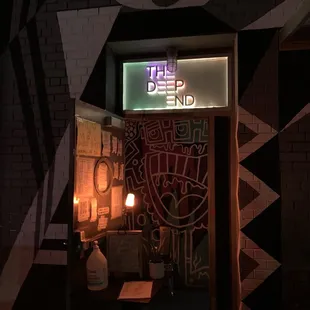 a neon sign above a doorway