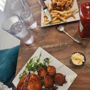 Grilled tuna burger with hushpuppies and honey butter, and chicken &amp; waffle sandwich
