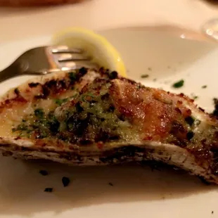 a half eaten oyster on a plate