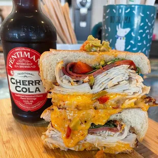 Hot Mess - House-made turkey, capicola, 3 cheese roasted red pepper spread, cherry peppers, arugula