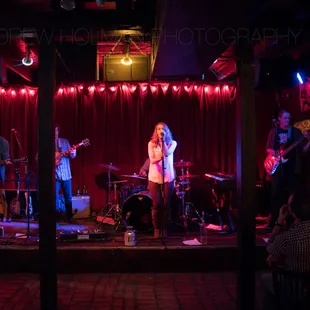 a band performing on stage at a bar