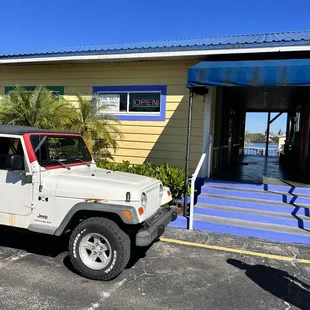 a jeep parked in front of a building