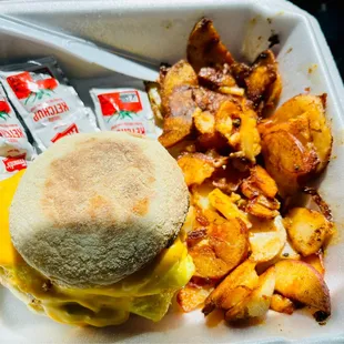 Sausage egg and cheese on English muffin with home fries. Need the ketchup too lol