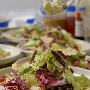 a plate of salad with a spoon