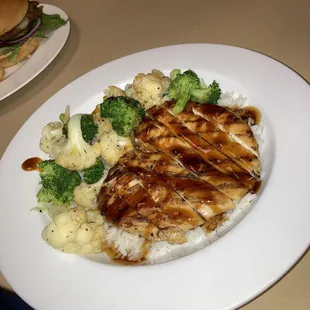 Teriyaki chicken and rice plate with mixed vegetables.