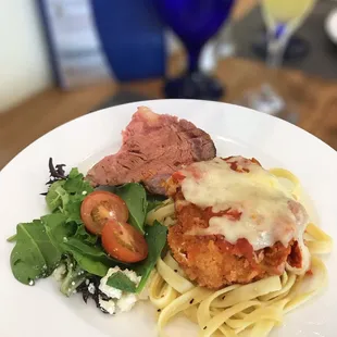 Salad, prime rib and chicken parm pasta.