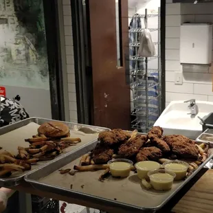 two trays of food being prepared