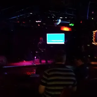 a band performing in a dark room