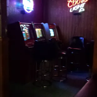 a row of slot machines in a bar