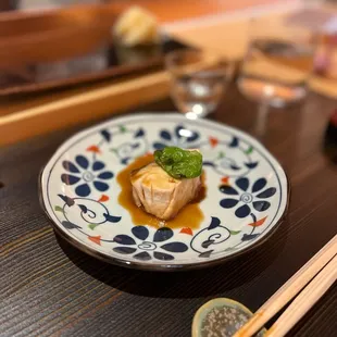 a plate of food and chopsticks