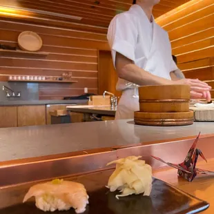 a chef preparing sushi in a restaurant