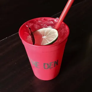 a red cup with a lime slice in it
