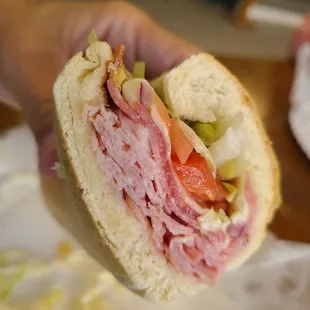 a person holding a sandwich in their hand