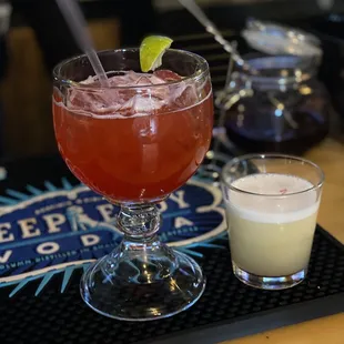 a drink with a lime garnish