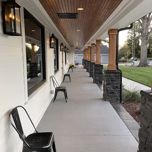 a row of chairs on the porch