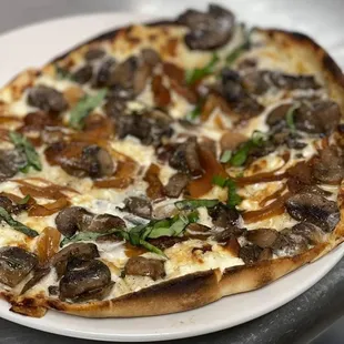 a mushroom pizza on a plate
