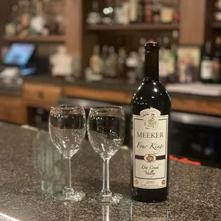 a bottle of wine and two wine glasses