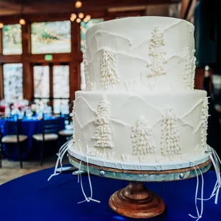a wedding cake on a blue table