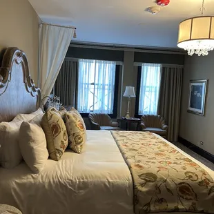 a bedroom with a bed and a chandelier