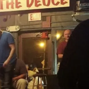 a man standing in front of a bar