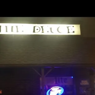 a neon sign above a bar