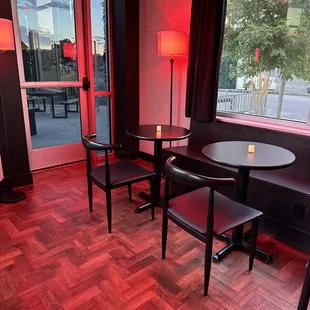 a table and chairs in front of a window