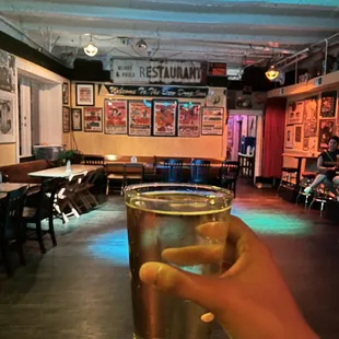 a person holding a glass of beer