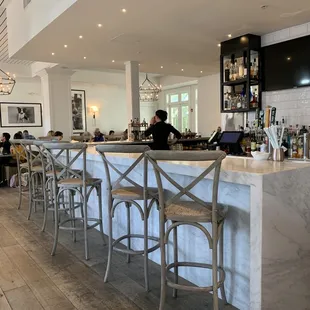 a bar with a marble counter and bar stools
