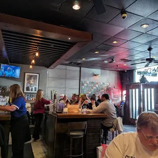 a group of people sitting at a bar