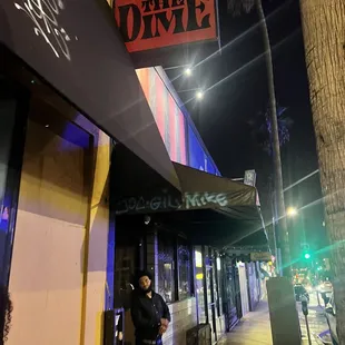 a man standing outside of a restaurant