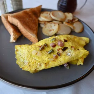 an omelet, toast and potatoes